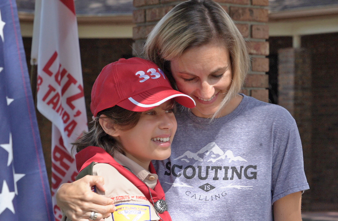 A proud mother embracing her BSA Scout