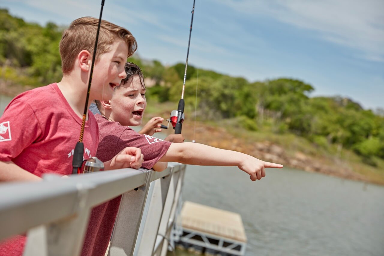 A young person enjoying a fishing activity